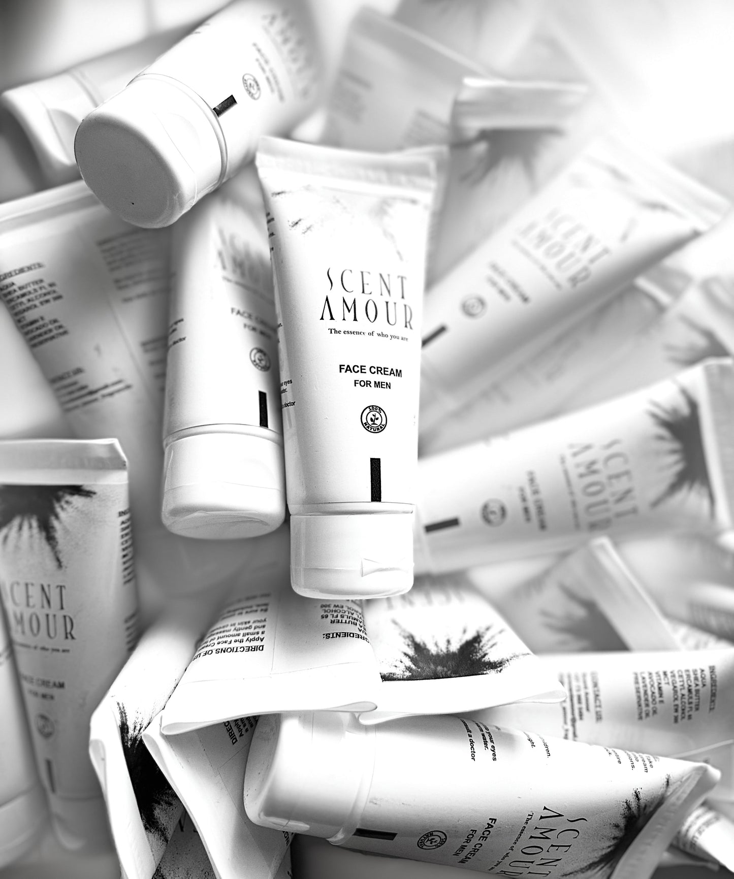Pile of Scent Amour face cream tubes and packaging