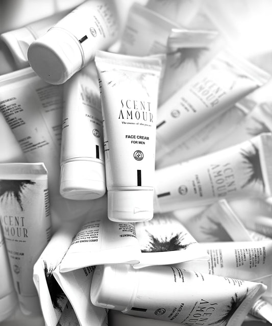 Pile of Scent Amour face cream tubes and packaging