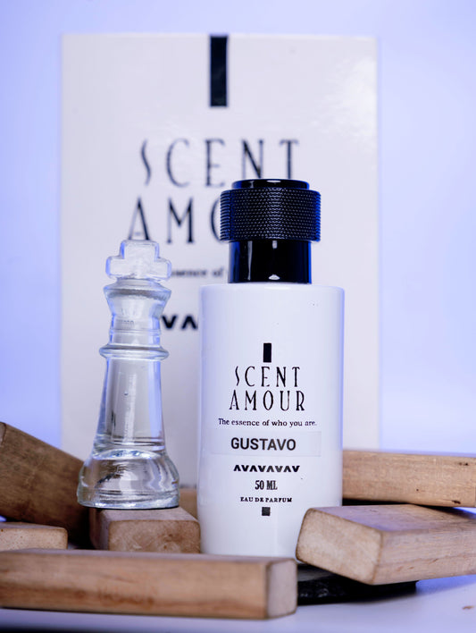 Perfume bottle labeled 'Scent Amour Gustavo' with a chess piece and wooden pieces on a light background