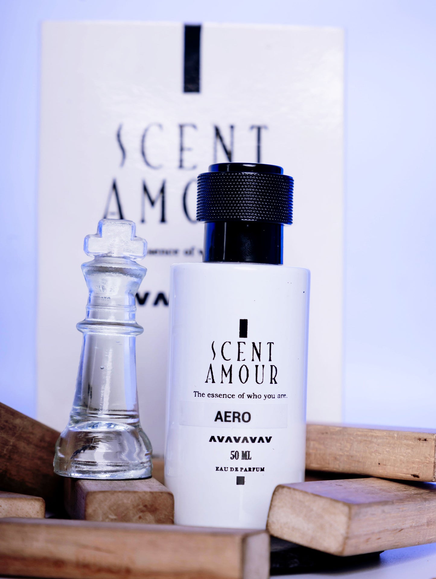 Perfume bottle labeled 'Scent Amour Aero' with a chess piece on a wooden surface.