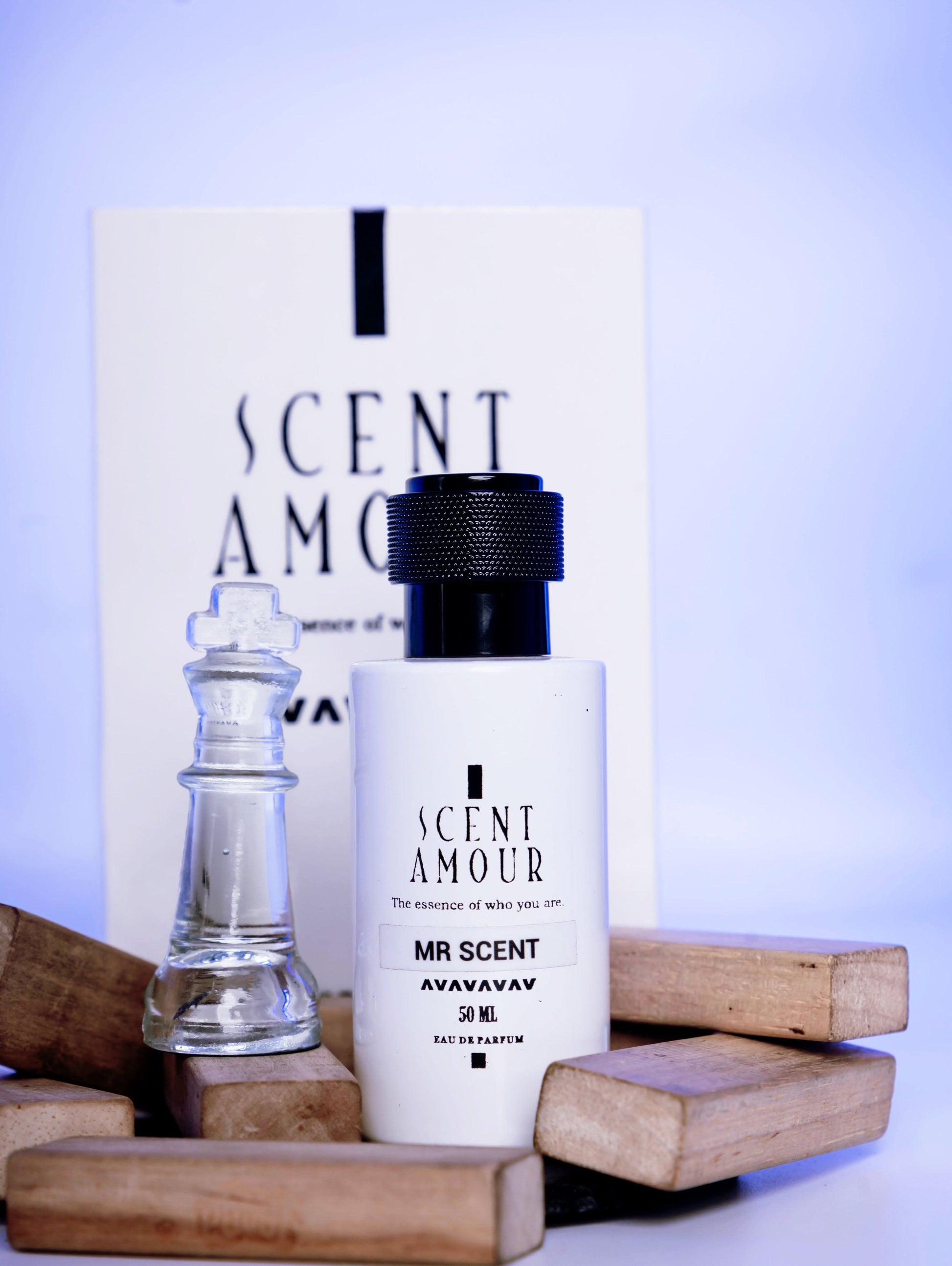 Perfume bottle and packaging with ' Scent Amour Mr Scent' branding on a wooden surface.