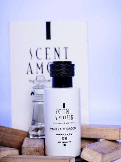 Perfume bottle labeled 'Scent Amour Vanilla Tobacco' with packaging on a wooden surface.