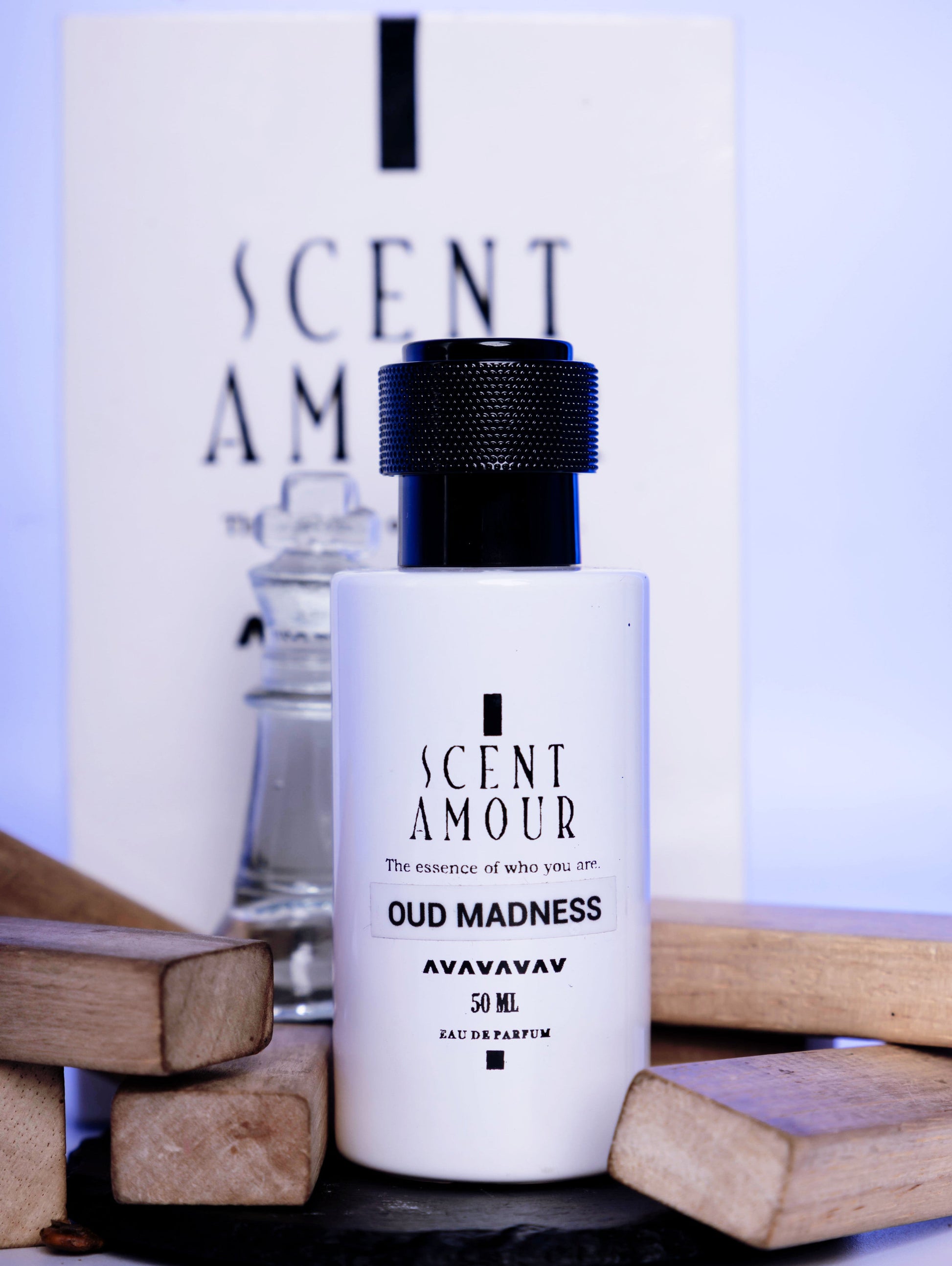 Perfume bottle labeled 'Scent Amour Oud Madness' with a blurred background
