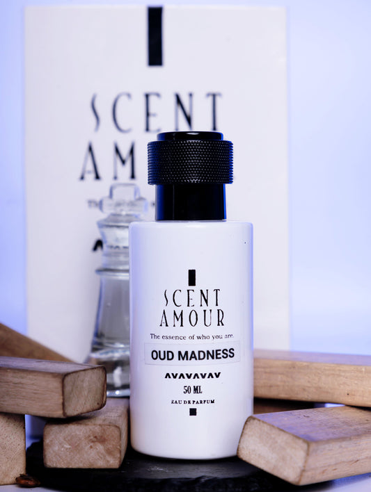 Perfume bottle labeled 'Scent Amour Oud Madness' with a blurred background