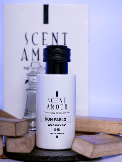 Perfume bottle labeled 'Scent Amour Don Pablo' with a box in the background