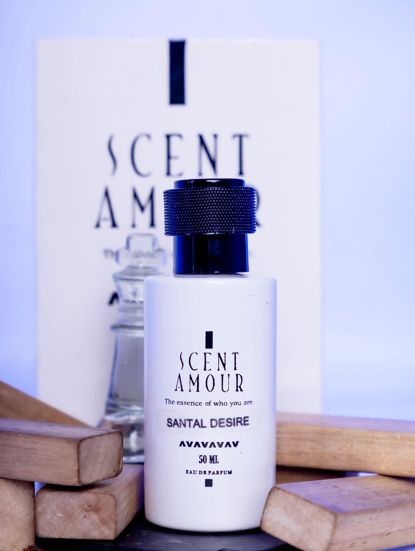 Perfume bottle with packaging labeled 'Scent Amour Santal Desire' on a light purple background